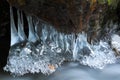 Winter creek in the national park Sumava, Czech Republic. Close-up of ice on a tree in winter. Melted icicles in the spring time Royalty Free Stock Photo