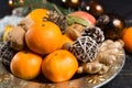 Winter cristmas fruits and nuts on silver plate Royalty Free Stock Photo