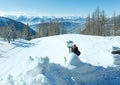 Winter Dachstein mountain massif and woman near the lamp.