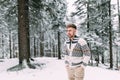 Outdoor portrait of handsome man in coat and scurf.