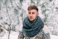 Outdoor portrait of handsome man in coat and scurf.