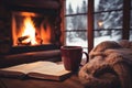 Winter day in cozy country house. Fireplace, cup of tea, coffee, cocoa, book and warm knitted plaid. View to snowy Royalty Free Stock Photo