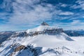 A winter day on the Diablerets glacier at 3000 meters above sea level in Switzerland with a blue sky with clouds. Royalty Free Stock Photo