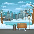 Winter day park. Snow covered wooden bench, trash bin and street lamp on an asphalt park trail with frozen lake and cityscape. Royalty Free Stock Photo