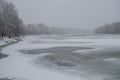 Winter day. River frozen - covered with ice and naked trees covered with white snow on there branches. Walking on nature