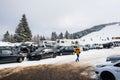 Winter day with snow and ski slope seen from parking area with k