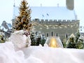 Winter Tallinn old town hall square yellow candle and white christmas ball in a snowdrift ,christmas tree blurred light ,snow