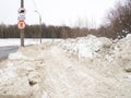 Winter day. Trees under the snow. Urban environment. Russian city. Large snowdrifts left over from snowplows Royalty Free Stock Photo