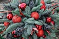 Winter decor. Beautiful arrangement of christmas tree red balls, cones, natural spruce branches for indoor outdoor festive