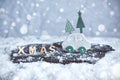 Christmas decoration with wooden car and XMAS letters in a miniature snow scene