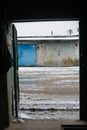 Winter dirty broken road in a garage cooperative. Gray depressing moody winter Royalty Free Stock Photo