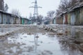 Winter dirty broken road in a garage cooperative. Gray depressing moody winter Royalty Free Stock Photo