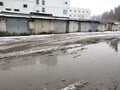 Winter dirty broken road in a garage cooperative. Gray depressing moody winter Royalty Free Stock Photo