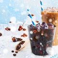 Winter drink iced coffee in a glass and ice coffee with cream in a tall glass surrounded by various spices