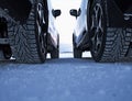 Winter drive safety. Studded tires against studless tires Royalty Free Stock Photo