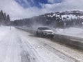 Winter driving on a highway with falling snow. The car is driving on a winter road in a blizzard Royalty Free Stock Photo