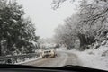 Winter driving, mountain road in snowstorm