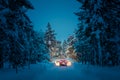 Winter Driving at night - Lights of car in snowy road Royalty Free Stock Photo
