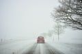 Winter driving by snowstorm poor visibility Royalty Free Stock Photo