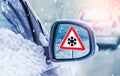 Winter driving - warning sign - risk of snow and ice. Winter driving - caution. Black Ice. Concept of snow in the road. Car hit a Royalty Free Stock Photo