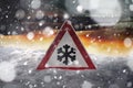 Road sign snow warns of snow and ice in winter, warning sign Royalty Free Stock Photo