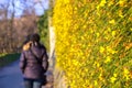 Winter end flower bloom spring arrival woman walk back blurred b