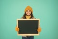 Winter entertainment and activities. Presentation concept. Smiling girl wear winter outfit blank chalkboard copy space