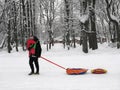 Winter entertainment, dad and baby, inflatable sledges, tubing Royalty Free Stock Photo