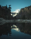 Reflection of a Snow Cladded Mountain falling on the lake water in the Old Manali town in Royalty Free Stock Photo