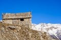 Winter evening landscape in french Alps. Old stone abandoned house on the mountain Royalty Free Stock Photo