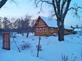 winter evening in the Russian village snow sunset pine trees Royalty Free Stock Photo