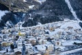 Winter evening in ski resort Ischgl in Tyrol Alps. Snow covered town is located among mountains and it`s getting dark very early.