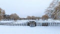 In winter everything is covered with snow, and the water channel in the city park is partially covered with ice. There is a fence Royalty Free Stock Photo