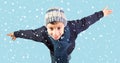 Winter - Excited little boy under falling snow