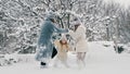 winter family fun. Happy family is enjoying of snow and snowfall, having fun outdoors, spending time together on snowy Royalty Free Stock Photo