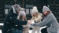 winter family fun. making snowballs. Happy family of 4 is enjoying of snow and snowfall, having fun outdoors, spending Royalty Free Stock Photo