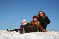 Winter family sit on snow