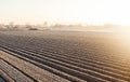 Winter farm field ready for new planting season. Preparatory agricultural work for spring. Choosing right time for sow fields Royalty Free Stock Photo