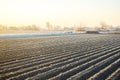 Winter farm field ready for new planting season. Preparatory agricultural work for spring. Choosing right time for sow fields