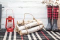 Winter farmhouse background with boots, logs and lantern Royalty Free Stock Photo