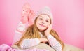 Winter fashion accessory. Kid girl knitted hat and scarf. Winter accessory concept. Girl long hair dream pink background