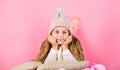 Winter fashion accessory. Kid girl knitted hat and scarf. Winter accessory concept. Girl long hair dream pink background Royalty Free Stock Photo