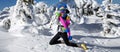 Winter fashion. Beautiful woman is wearing silver jacket, ski goggles and colorful beanie and scarf. Mountain climbing. Szrenica,