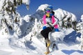 Winter fashion. Beautiful woman is wearing silver jacket, ski goggles and colorful beanie and scarf. Mountain climbing. Szrenica,