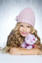 Winter fashion cap little girl hug teddy bear Royalty Free Stock Photo