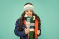 winter fashion. emotional kid with curly hair in hat and scarf. teen girl in puffer jacket