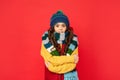 winter fashion. kid with curly hair in hat feel cold. female fashion model. teen girl in scarf.