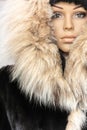 Winter fashion stylish elegant clothes. Female fur coat with a hood Royalty Free Stock Photo