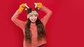 winter fashion for winking teen girl. teen girl fashion model in winter earflap hat. teen girl Royalty Free Stock Photo