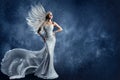 Winter Fashion Woman in Silver Sequin Dress. Beauty Model in Long Sparkle Glittering Gown over Fantasy Blue Snowy Christmas